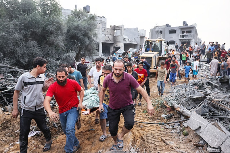 Palestinians transport the body of a victim from the rubble after Israeli strikes in Rafah in the southern Gaza Strip on October 23, 2023, amid ongoing battles between Israel and the Palestinian Hamas group. Image: MOHAMMED ABED / AFP