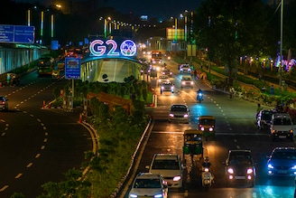 Traffic moves past an illuminated G20 logo installed on pedestrian bridge outside the main venue near Pragati Maidan. The G20 (Global economic cooperation forum comprised of 19 individual countries) Summit, which is scheduled to be held in New Delhi on September 9th and 10th 2023, will be attended by 20 or so world leaders. This year will be the 18th G20 Summit and India"s first in terms of presidency. Image: Pradeep Gaur/SOPA Images/LightRocket via Getty Images