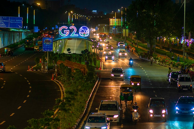 Traffic moves past an illuminated G20 logo installed on pedestrian bridge outside the main venue near Pragati Maidan. The G20 (Global economic cooperation forum comprised of 19 individual countries) Summit, which is scheduled to be held in New Delhi on September 9th and 10th 2023, will be attended by 20 or so world leaders. This year will be the 18th G20 Summit and India"s first in terms of presidency. Image: Pradeep Gaur/SOPA Images/LightRocket via Getty Images