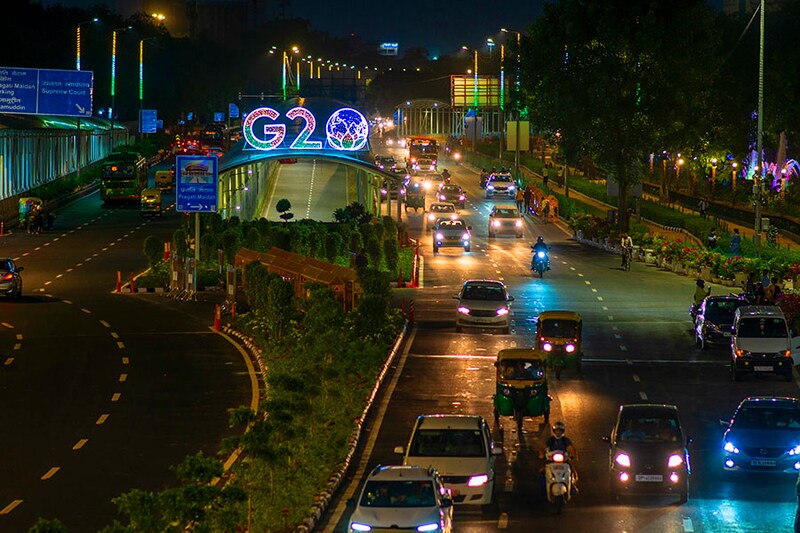 Traffic moves past an illuminated G20 logo installed on pedestrian bridge outside the main venue near Pragati Maidan. The G20 (Global economic cooperation forum comprised of 19 individual countries) Summit, which is scheduled to be held in New Delhi on September 9th and 10th 2023, will be attended by 20 or so world leaders. This year will be the 18th G20 Summit and India"s first in terms of presidency. Image: Pradeep Gaur/SOPA Images/LightRocket via Getty Images