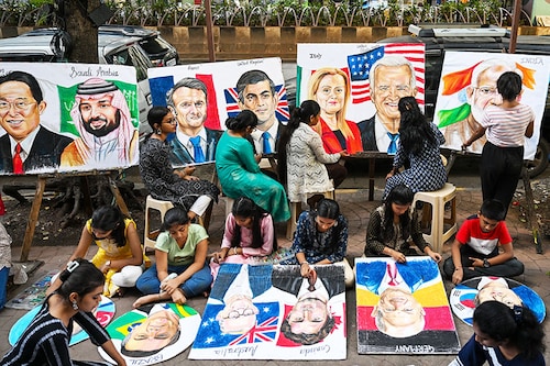 Students work on paintings of world leaders at an art school in Mumbai on September 5, 2023, ahead of the two-day G20 summit in New Delhi.