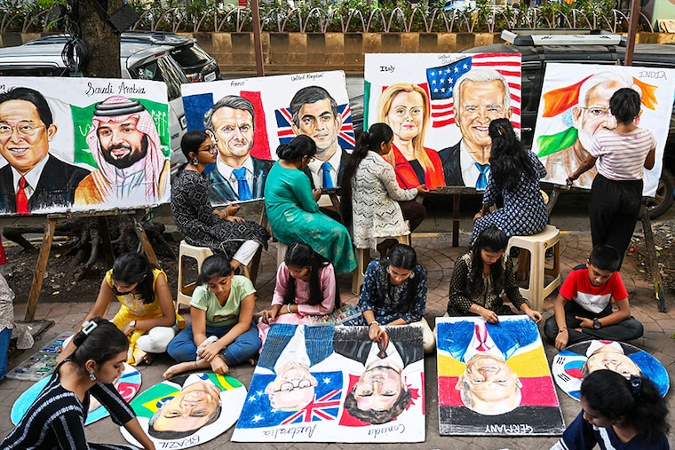 Students work on paintings of world leaders at an art school in Mumbai on September 5, 2023, ahead of the two-day G20 summit in New Delhi.