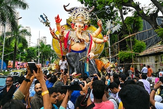 Ahead of the Ganesh Chaturthi festival, devotees carry an idol of Hindu deity "Ganesha" during a procession along a street in Mumbai on September 17, 2023.
