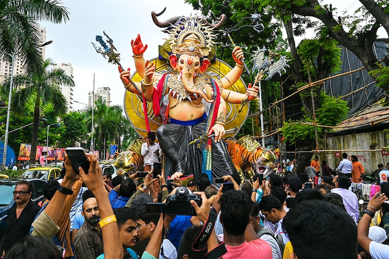 Ahead of the Ganesh Chaturthi festival, devotees carry an idol of Hindu deity "Ganesha" during a procession along a street in Mumbai on September 17, 2023.