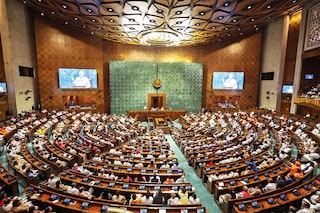 PM Modi addressing MPs in the new Parliament building. Image: Photo by PIB / AFP