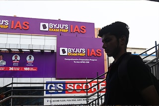 (File photo) A boy walks past a hoarding of Byju"s IAS coaching centre in New Delhi, India, on June 24, 2023. Image: Kabir Jhangiani/NurPhoto