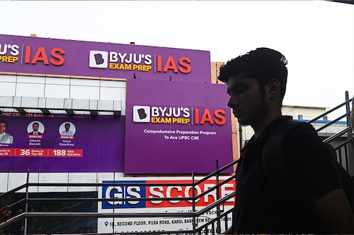 (File photo) A boy walks past a hoarding of Byju"s IAS coaching centre in New Delhi, India, on June 24, 2023. Image: Kabir Jhangiani/NurPhoto