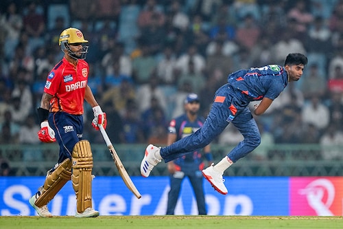 Lucknow Super Giants" Mayank Yadav bowls as Punjab Kings" captain Shikhar Dhawan (L) watches during the Indian Premier League (IPL) Twenty20 cricket match between Lucknow Super Giants and Punjab Kings at the Ekana Cricket Stadium in Lucknow on March 30, 2024.
Image: Arun Sankar / AFP