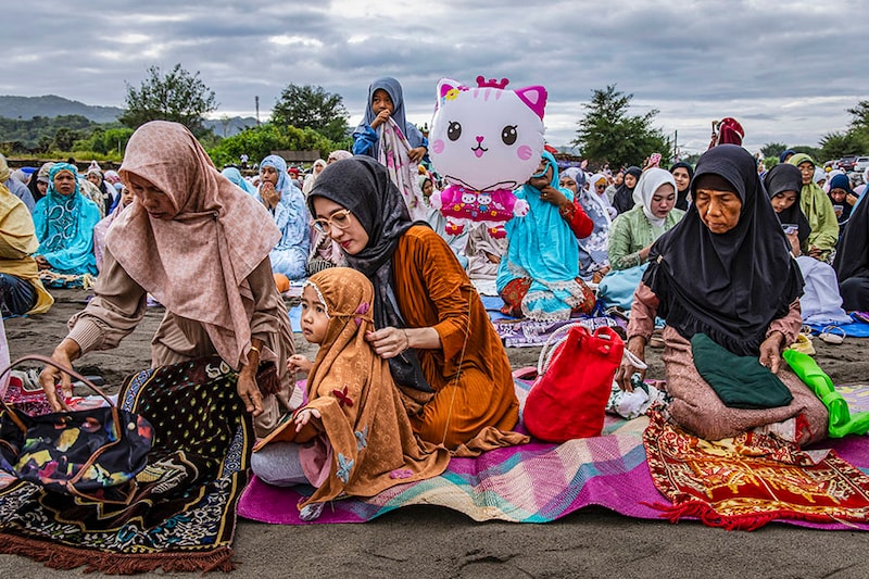 Indonesian Muslims attend the Eid Al-Fitr prayer on the "sea of sands" at Parangkusumo beach on April 10, 2024, in Yogyakarta, Indonesia. Muslims around the world celebrate Eid al-Fitr with their families with feasts to mark the end of Ramadan, the holy month of fasting.