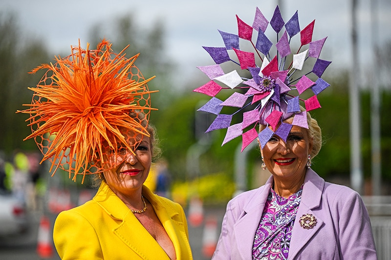 Racegoers pose for a photograph as they attend on Ladies Day, the second day of the Grand National Festival horse race meeting at Aintree Racecourse in Liverpool, north-west England, on April 12, 2024.