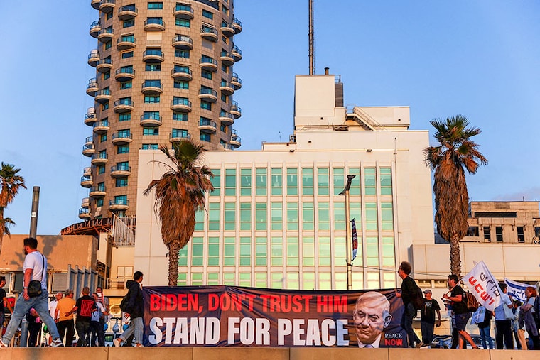 People hold a banner outside the US Embassy Branch Office during a protest in support of the US president Joe Biden after Iran launched drones and missiles towards Israel, in Tel Aviv, Israel, on April 15, 2024.