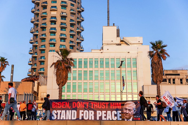 People hold a banner outside the US Embassy Branch Office during a protest in support of the US president Joe Biden after Iran launched drones and missiles towards Israel, in Tel Aviv, Israel, on April 15, 2024.