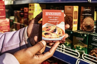 A shopkeeper is holding packets of Everest"s Fish Curry Masala at a department store in Baramulla, Jammu and Kashmir, India, on April 23, 2024. The said masala has been put under the scanner in Singapore for containing cancer causing chemicals. Image: Getty Images