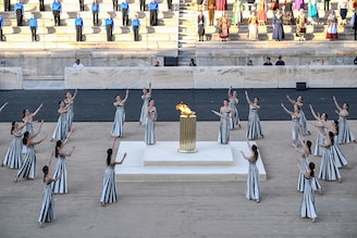 Priestesses perform a dance during the handover ceremony of the Olympic Flame for the Paris 2024 Summer Olympic and Paralympic Games at the Panathinean stadium in Athens, on April 26, 2024. The ceremony marks the culmination of an 11-day Olympic Torch Relay across Greece and begins an epic three-month torch relay and countdown to the Opening Ceremony of the Paris 2024 Olympic Games, on 26 July, 2024.