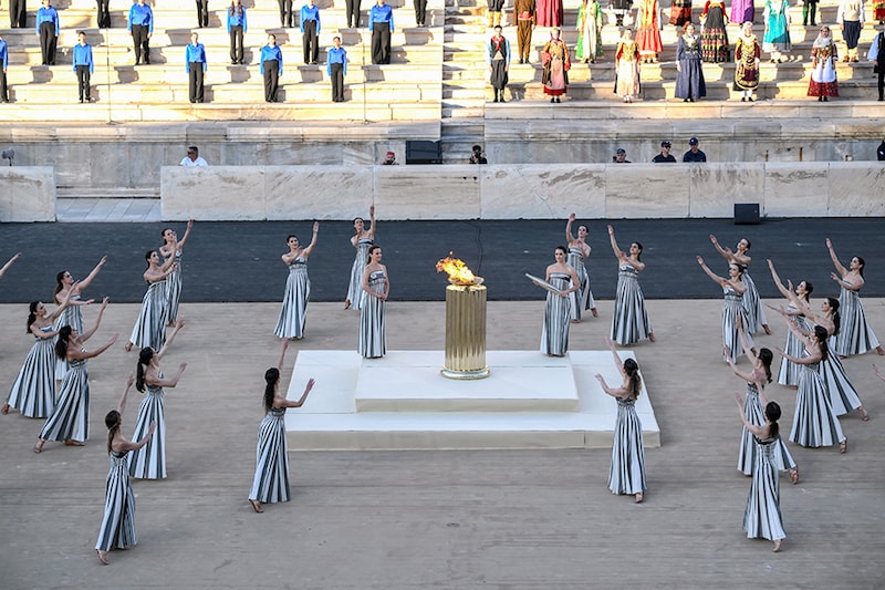 Priestesses perform a dance during the handover ceremony of the Olympic Flame for the Paris 2024 Summer Olympic and Paralympic Games at the Panathinean stadium in Athens, on April 26, 2024. The ceremony marks the culmination of an 11-day Olympic Torch Relay across Greece and begins an epic three-month torch relay and countdown to the Opening Ceremony of the Paris 2024 Olympic Games, on 26 July, 2024.