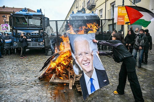 Activists burn a portrait of US President Joe Biden and G7 leaders during a demonstration against the G7 Climate, Energy and Environment held in Turin, on April 28, 2024, in Venaria Reale, near Turin, Italy.