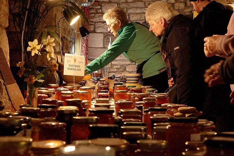 A screenshot taken from an AFP TV video, shows people browsing jars of marmalade entered into the annual Dalemain world marmalade awards, in Penrith. Photography Justine GERARDY / AFPÂ©