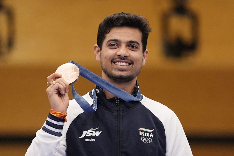 Swapnil Kusale of India poses with a bronze medal he won in the 50m rifle 3 positions event in the Summer Olympics games being held in Paris.
