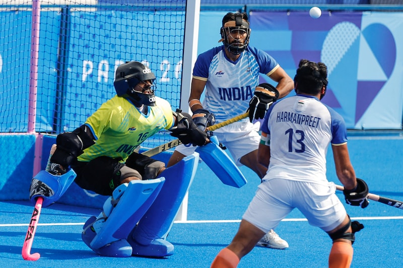Harmanpreet Singh of India and goalie Sreejesh Raveendran of India in action during a penalty corner in the men"s hockey quarter final against Great Britain in Yves-du-Manoir Stadium, Colombes, France, at the Olympic Games, on August 04, 2024. In a remarkable defensive performance, the Indian team played with one player less for 42 minutes to a 1-1 draw and won 4-2 in the shootout to qualify for the semi-finals. Image: Adnan Abidi / Reuters