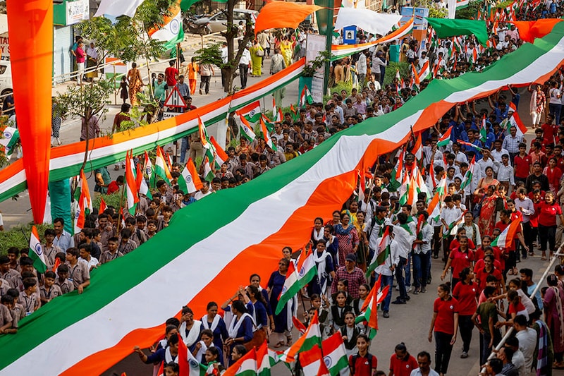 Students hold a giant Indian national flag during a "Tiranga Yatra" rally as part of the ongoing celebrations commemorating 77 years of India"s Independence, in Ahmedabad, India, August 13, 2024. Image: Reuters/Amit Dave