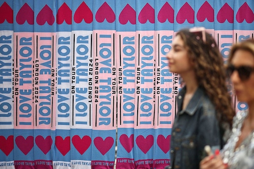 Fans of US mega-star Taylor Swift, so-called "Swifties", pass merchandise stalls outside Wembley Stadium in London.
Image: Henry Nicholas / AFPÂ©