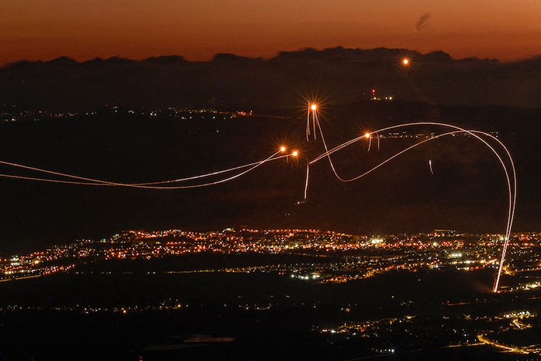 Rockets fired from southern Lebanon are intercepted by Israel"s Iron Dome air defence system over the Upper Galilee region in northern Israel on August 23, 2024.