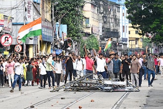 Activists shout slogans as they march towards the state secretariat demanding the resignation of West Bengal CM Mamata Banerjee in Kolkata on August 27, 2024. Police fired tear gas and water cannon as they clashed with thousands of protesters seeking justice for a doctor who was raped and murdered in Kolkata this month.
