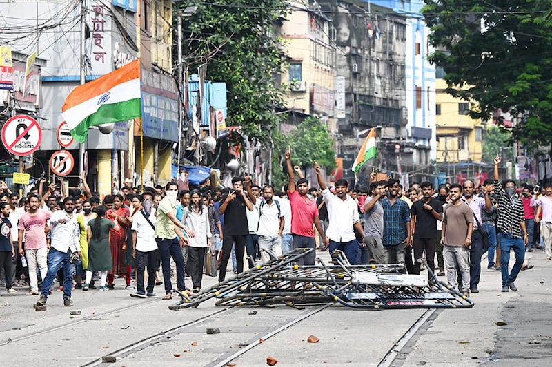 Activists shout slogans as they march towards the state secretariat demanding the resignation of West Bengal CM Mamata Banerjee in Kolkata on August 27, 2024. Police fired tear gas and water cannon as they clashed with thousands of protesters seeking justice for a doctor who was raped and murdered in Kolkata this month.