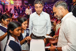 Rishad Premji (centre), Wipro’s executive chairman and the eldest son of founder Azim Premji, and chief sustainability officer Anurag Behar meet schoolchildren at an event Image: Manjunath Kiran/ AFP