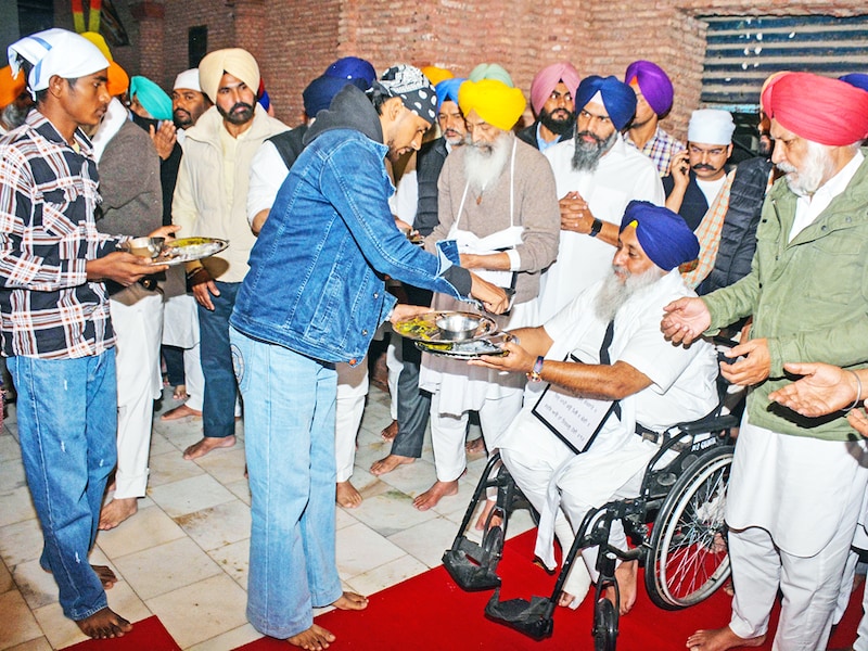 As per tankhah (religious punishment) awarded by Akal Takht, Shiromani Akali Dal (SAD) president Sukhbir Singh Badal, SAD working president Balwinder Singh Bhunder, SAD leader Daljeet Singh Cheema, Gulzar Singh Ranike performing sewa of collecting used utensils at Langar Hall in Golden Temple on December 3, 2024 in Amritsar, India. On Wednesday, Badal was allegedly attacked by a gunman at the Golden Temple while performing penance duties. The Akal Takht, the supreme temporal body of the Sikhs, punished Akali leaders for the mistakes the Shiromani Akali Dal committed during its alliance with the Bharatiya Janata Party (BJP) from 2007 to 2017.