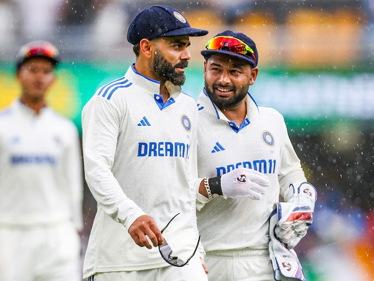 India"s Virat Kohli (L) and Rishabh Pant return to the dugout after rain delays play on the first day of the third cricket Test match between Australia and India at The Gabba in Brisbane on December 14, 2024.