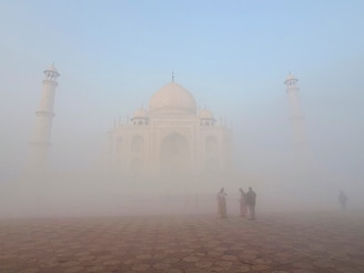 The Taj Mahal is shrouded in a dense fog during a cold winter morning in Agra on Wednesday, December 18, 2024. Several parts of northern and eastern India continued to reel under cold wave conditions as minimum temperatures further plunge
