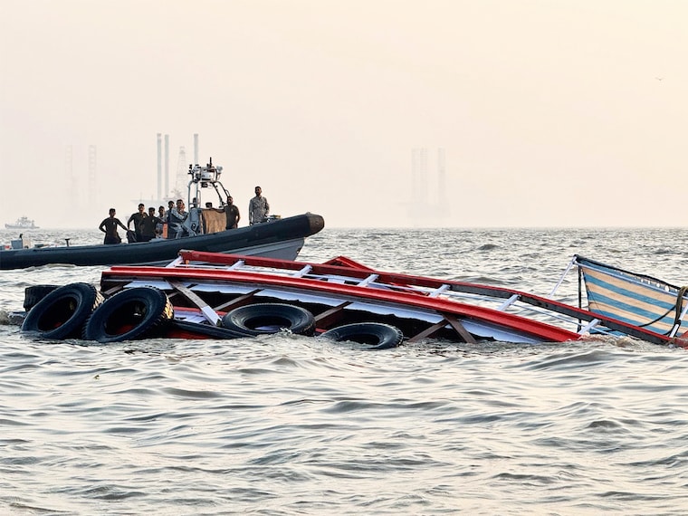 This handout photograph taken on December 18, 2024 and released by the Indian Coast Guard (ICG) shows Indian defence personnel carrying out rescue operation after an accident off the coast of Mumbai. An Indian navy speedboat undergoing tests in the busy seas off the financial capital Mumbai lost control. It slammed into a ferry, killing 13 people, the navy and government said on December 18.
