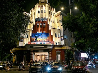 Pedestrians walk past the Eros Cinema, a UNESCO-designated Art Deco cinema theatre in the Cambata Building at Churchgate in Mumbai. Image: Indranil MUKHERJEE / AFP©