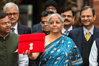 India"s Finance Minister Nirmala Sitharaman and her staff pose for pictures as she leaves the Finance Ministry Office to present the annual budget in parliament in New Delhi on February 1, 2024.