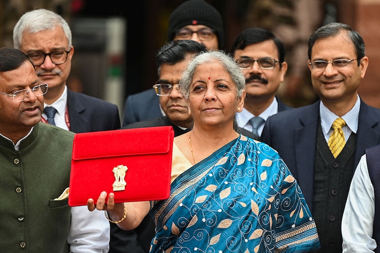 India"s Finance Minister Nirmala Sitharaman and her staff pose for pictures as she leaves the Finance Ministry Office to present the annual budget in parliament in New Delhi on February 1, 2024.