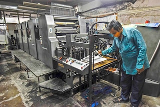 A man working on an offset printer at a printing unit at Okhla industrial area in New Delhi, India. Image: Biplov Bhuyan/Hindustan Times via Getty Images