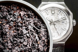 A photo taken on December 4, 2023 in Geneva shows parts of a plastic-free compostable material recycled for a vegan strap in front of a picture of a Circular model watch by ID Geneve brand.  
Image: Fabrice Coffrini / AFP