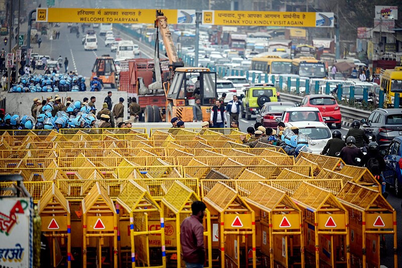 Delhi Police and Security Forces officials preparing security arrangements at the Singhu Border Delhi-Haryana Border, ahead of the farmers" call for March to Delhi on 13th February, on February 12, 2024, in New Delhi, India. Farmers from across multiple states bordering the country"s capital have launched their "Chalo Delhi" march on February 13, putting forth their list of demands for the central government to take into account.