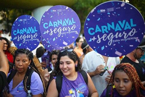 Workers from Rio de Janeiro"s City Hall promote a campaign for safer carnival for women during the parade of the street carnival group Loucura Suburbana.
Image: Mauro Pimentel / AFPÂ©