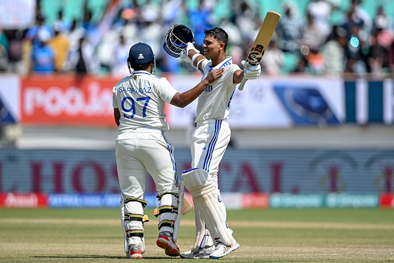 India"s Yashasvi Jaiswal celebrates with his teammate Sarfaraz Khan (L) after scoring a double century during the fourth day of the third Test cricket match between India and England at the Niranjan Shah Stadium in Rajkot on February 18, 2024.