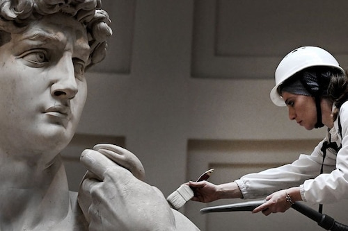 Italian restorer Eleonora Pucci cleans Michelangelo"s statue of David using a backpack vacuum and synthetic fibre brush at the Galleria dell"Accademia, in Florence on February 19, 2024. Image: Tiziana Fabi/ AFP© Italian restorer Eleonora Pucci cleans Michelangelo"s statue of David using a backpack vacuum and synthetic fibre brush at the Galleria dell"Accademia, in Florence on February 19, 2024. Image: Tiziana Fabi/ AFP©