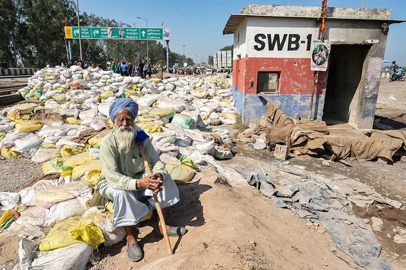 A farmer looks on during an ongoing protest to demand minimum crop prices near the Punjab-Haryana state border at Shambhu in Patiala district on February 22, 2024. Thousands of Indian farmers last week launched what they have dubbed "Delhi Chalo", or "March to Delhi", to demand a law to fix a minimum price for their crops, in addition to other concessions, including the waiving of loans.