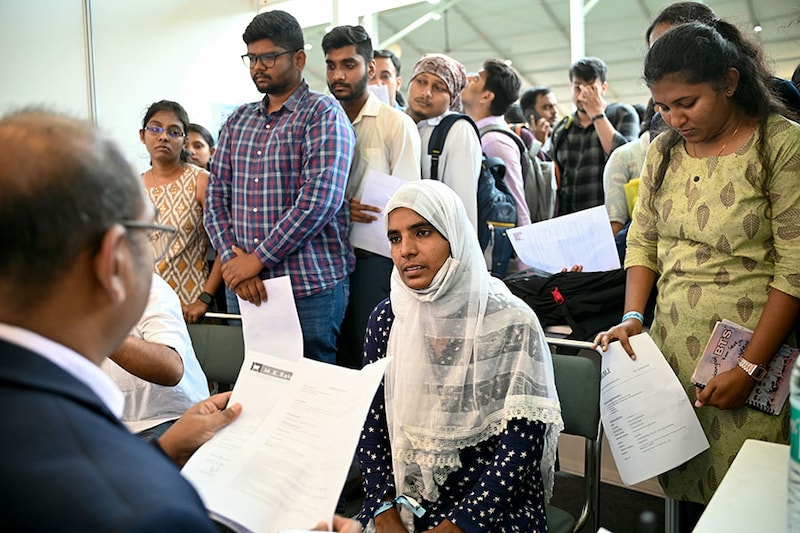Job seekers attend a walk-in-interview during a state-level job fair organised by India"s Karnataka state government at the Palace Grounds in Bengaluru on February 26, 2024. On day one, 95,000 registered for two-day job fair.