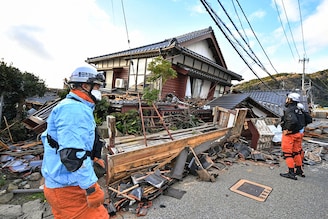 Firefighters inspect collapsed wooden houses in Wajima, Ishikawa prefecture in Japan, on January 2, 2024, a day after a major 7.5 magnitude earthquake struck the Noto region in Ishikawa prefecture in the afternoon. Japanese rescuers battled against the clock and powerful aftershocks on January 2 to find survivors after a major earthquake that struck on New Year"s Day, reportedly killing more than 20 people and leaving a trail of destruction.