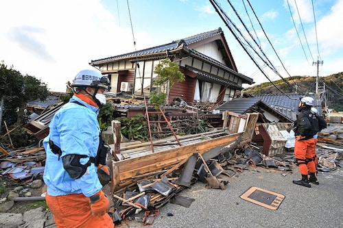 Firefighters inspect collapsed wooden houses in Wajima, Ishikawa prefecture in Japan, on January 2, 2024, a day after a major 7.5 magnitude earthquake struck the Noto region in Ishikawa prefecture in the afternoon. Japanese rescuers battled against the clock and powerful aftershocks on January 2 to find survivors after a major earthquake that struck on New Year"s Day, reportedly killing more than 20 people and leaving a trail of destruction.