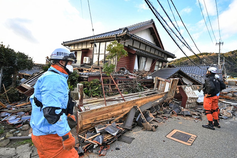 Firefighters inspect collapsed wooden houses in Wajima, Ishikawa prefecture in Japan, on January 2, 2024, a day after a major 7.5 magnitude earthquake struck the Noto region in Ishikawa prefecture in the afternoon. Japanese rescuers battled against the clock and powerful aftershocks on January 2 to find survivors after a major earthquake that struck on New Year"s Day, reportedly killing more than 20 people and leaving a trail of destruction.