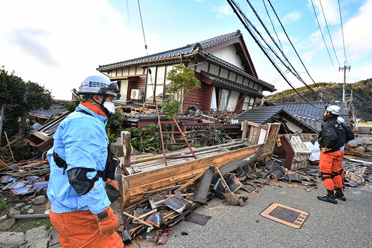 Firefighters inspect collapsed wooden houses in Wajima, Ishikawa prefecture in Japan, on January 2, 2024, a day after a major 7.5 magnitude earthquake struck the Noto region in Ishikawa prefecture in the afternoon. Japanese rescuers battled against the clock and powerful aftershocks on January 2 to find survivors after a major earthquake that struck on New Year"s Day, reportedly killing more than 20 people and leaving a trail of destruction.