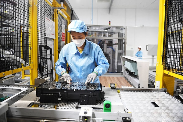 A worker assembles an electric car battery inside the battery pack shop at the electric automobile plant of VinFast in Haiphong, Vietnam. Image: Nhac Nguyen / AFP)
