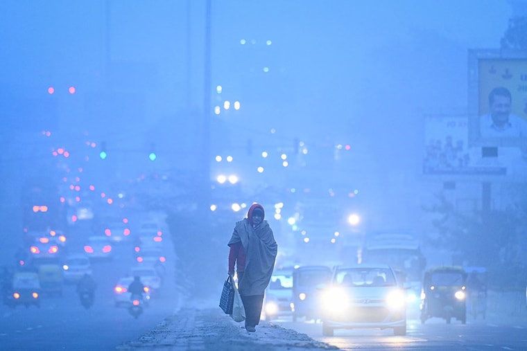 Commuters wading through early morning breeze and foggy weather at Kirti Nagar on January 9, 2024 in New Delhi, India. Delhi and its adjoining areas woke up to a cold and foggy morning on Tuesday, and the national capital"s minimum temperature dropped to 6 degrees Celsius.